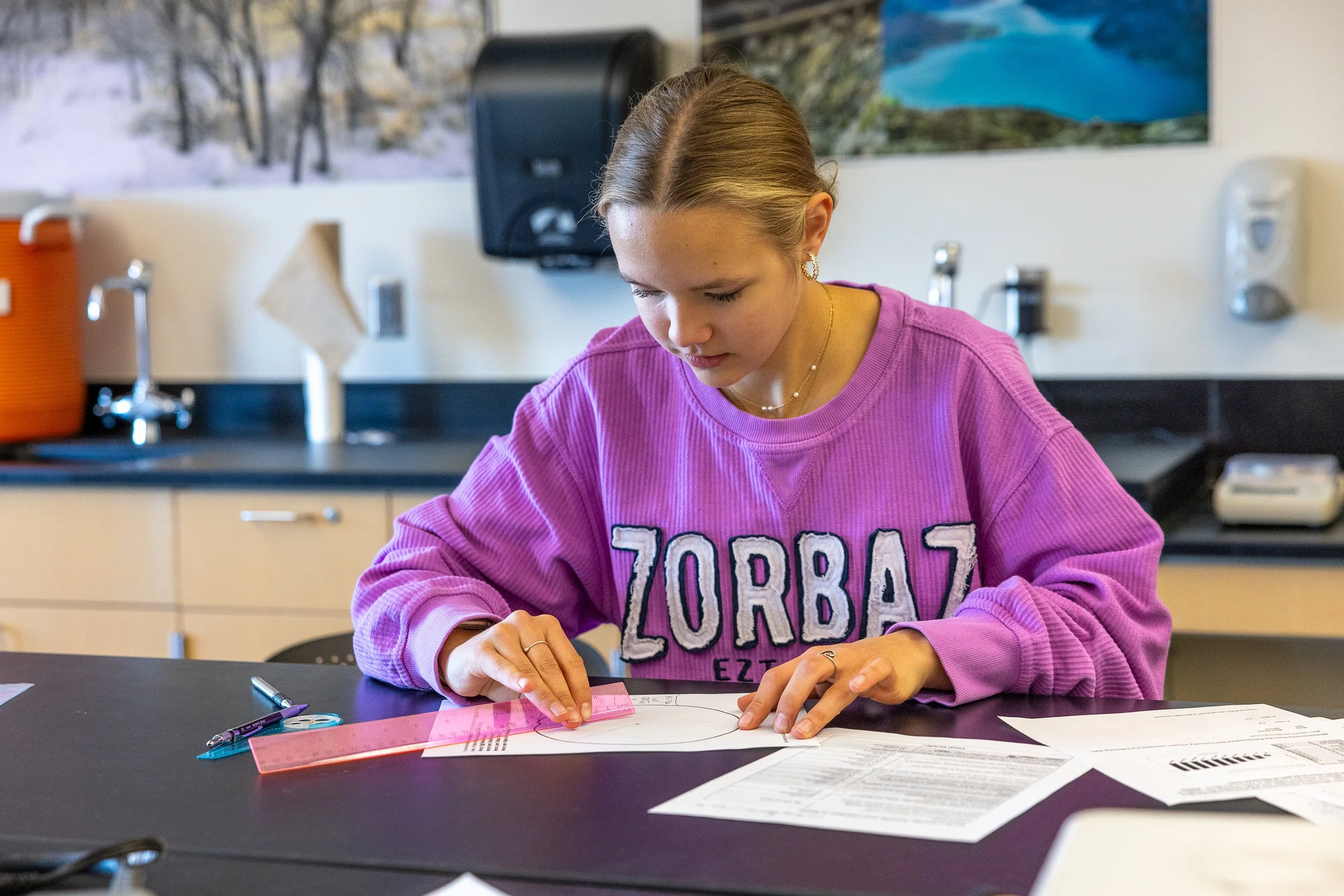 Young teen working on a math problem.