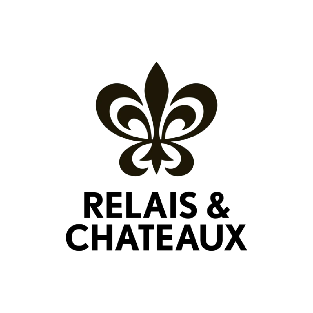 Gold fleur-de-lis logo on a black background.