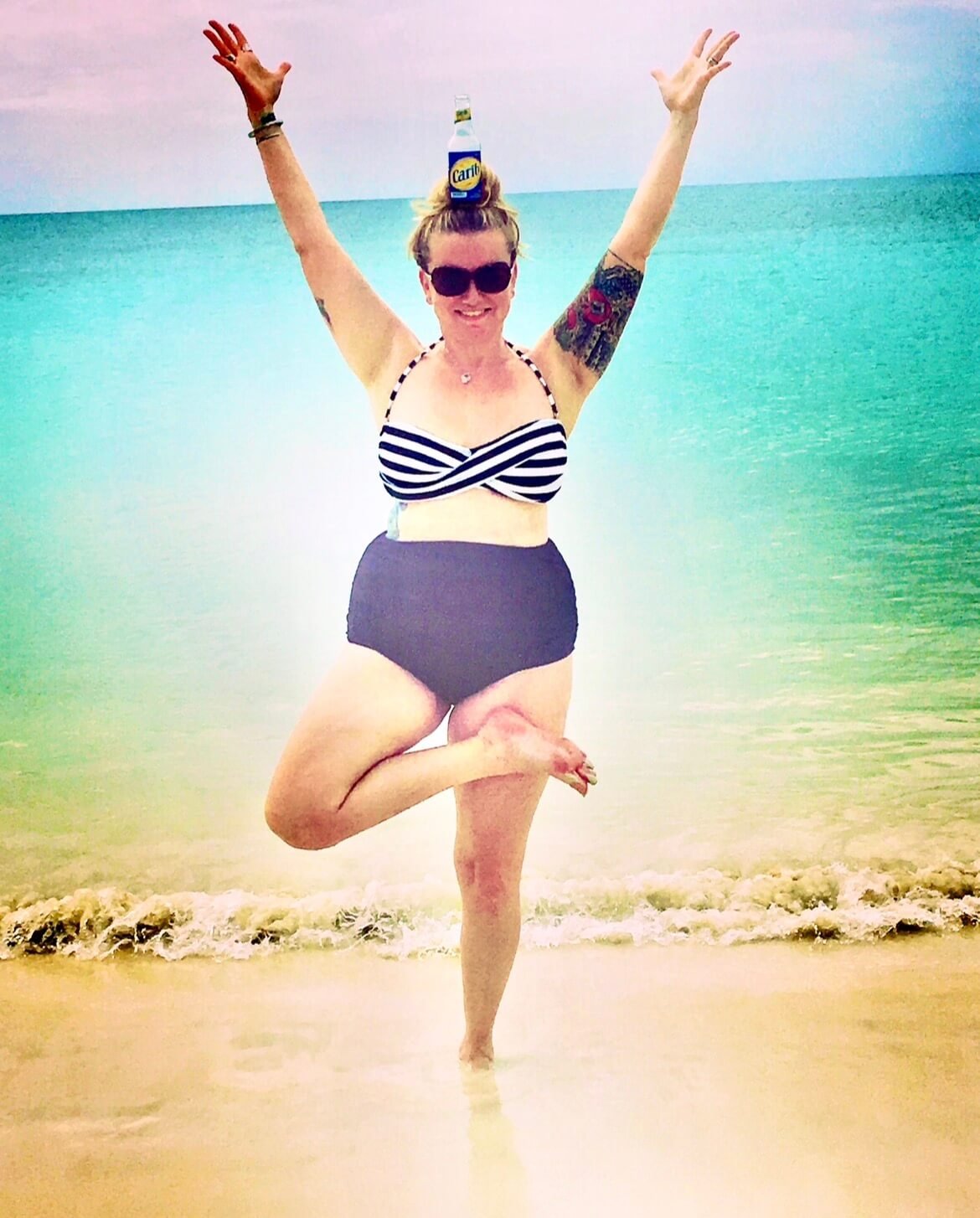 Shannon Somogyi at the beach balancing in yoga pose during retreat in Mexico.