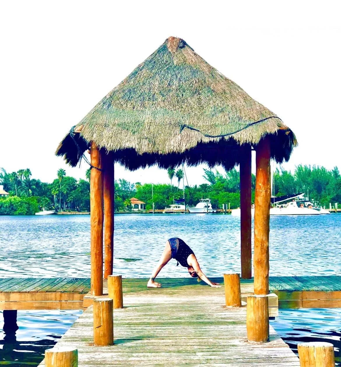 Shannon Somogyi at the beach balancing in yoga pose during retreat in Mexico.