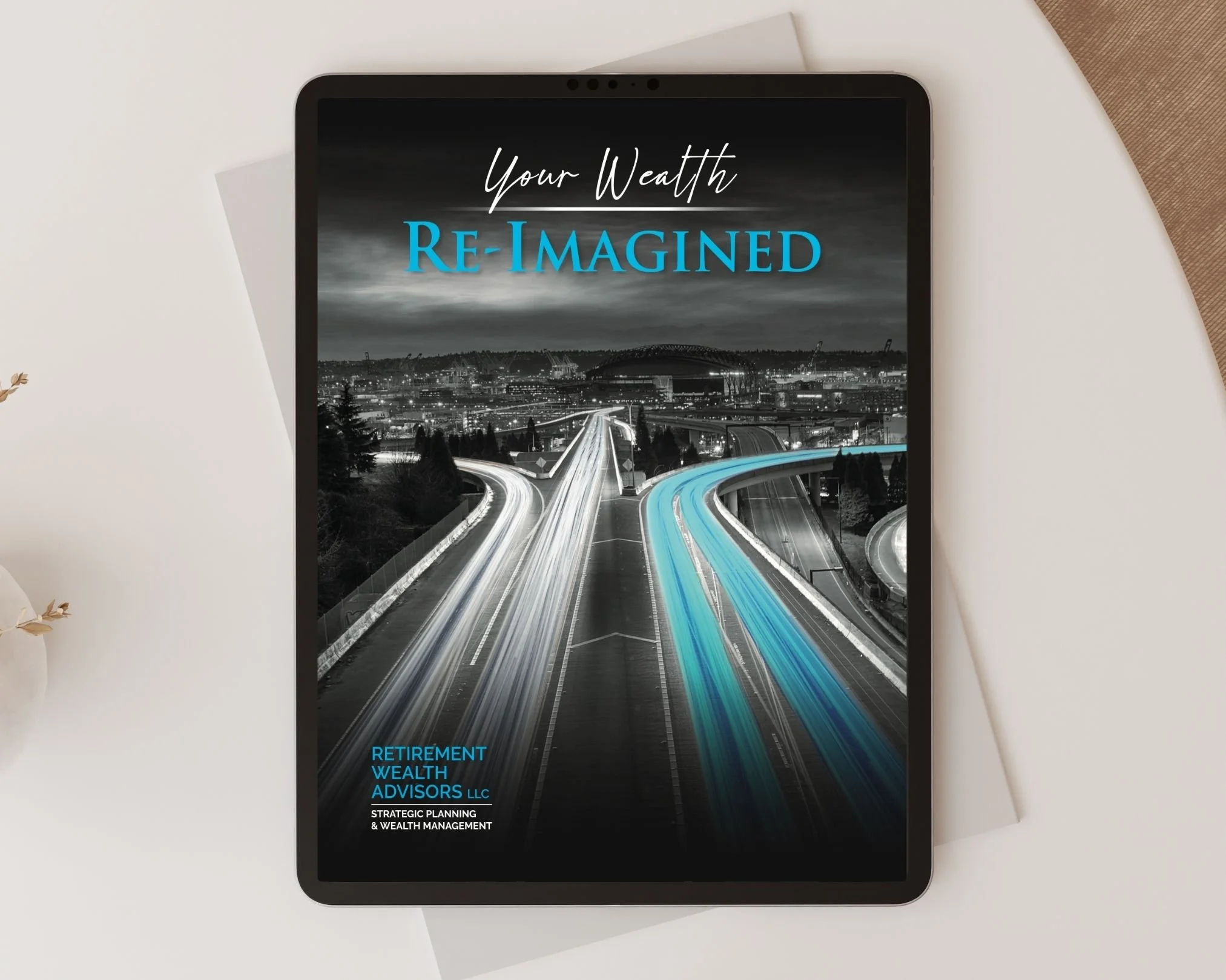 A tablet on a white surface displaying financial advisory services with a background of a city highway at night and overcast sky, with the words "Your Wealth Re-Imagined" and contact information for wealth management services.