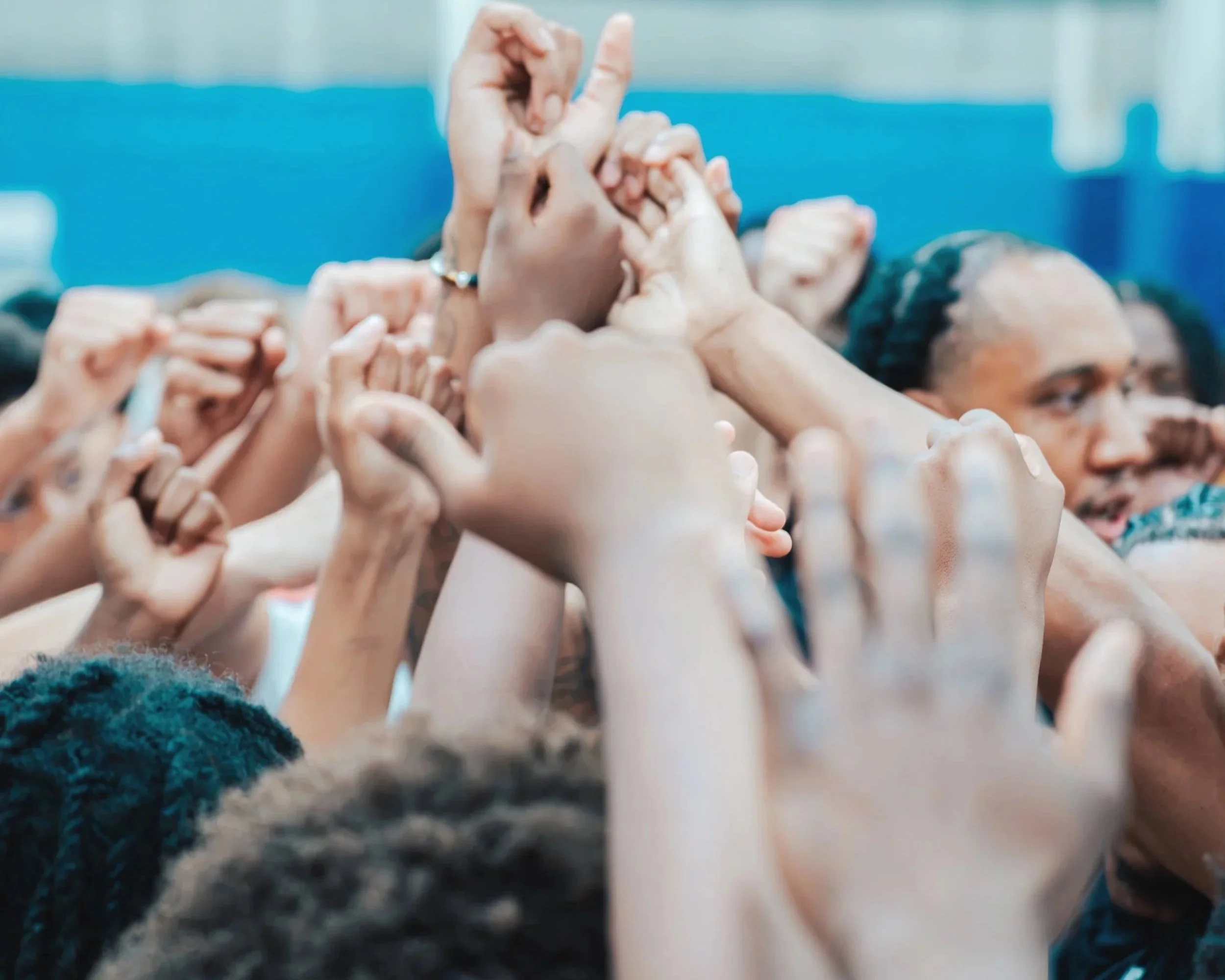 People forming a human chain by linking their hands.