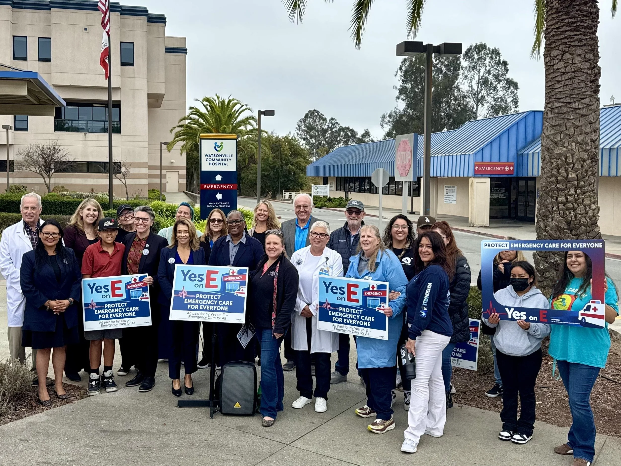 A group of people holding "Yes on E" signs