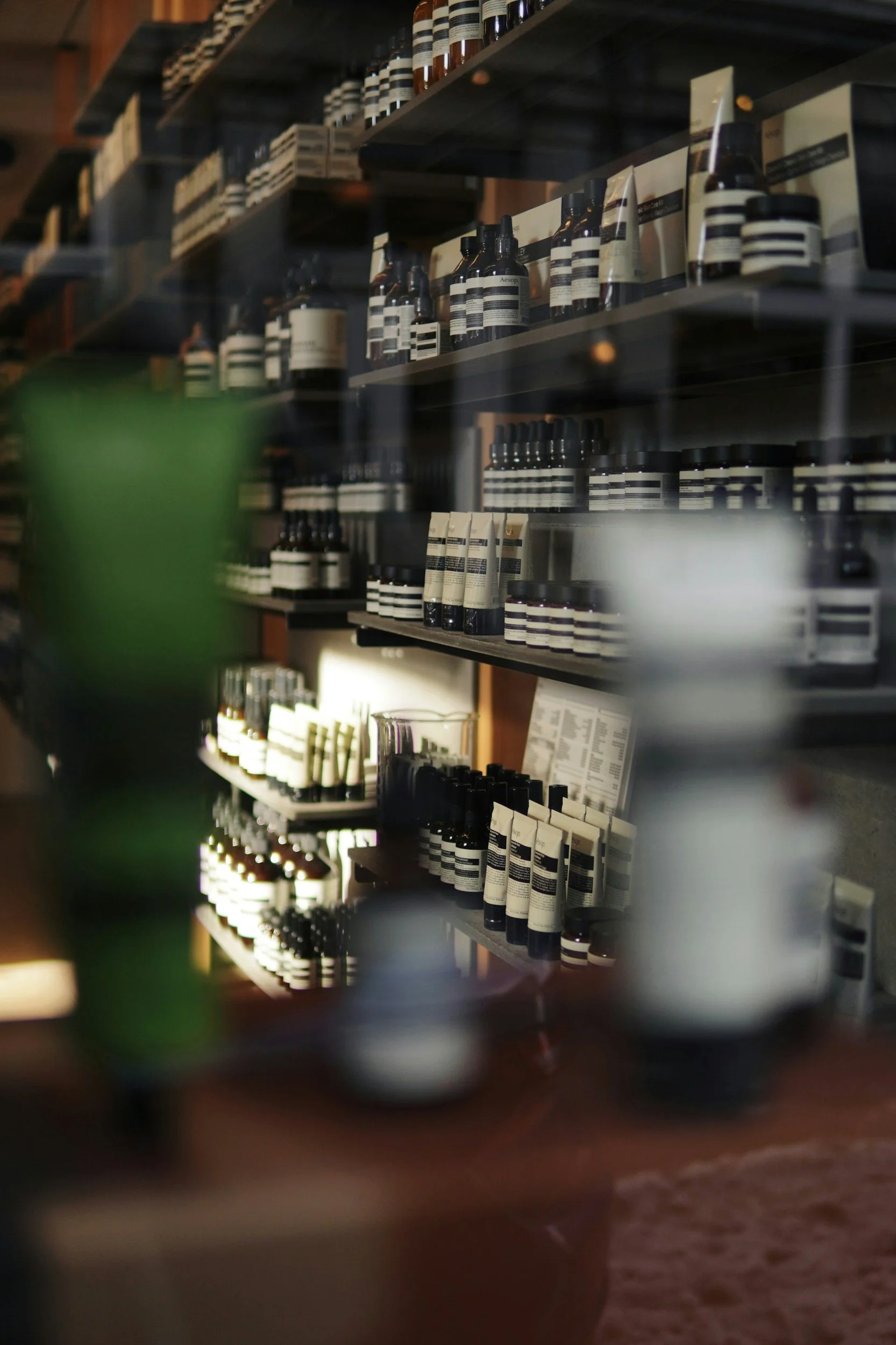 Shelves stocked with various bottles and jars of personal care products in a retail store.