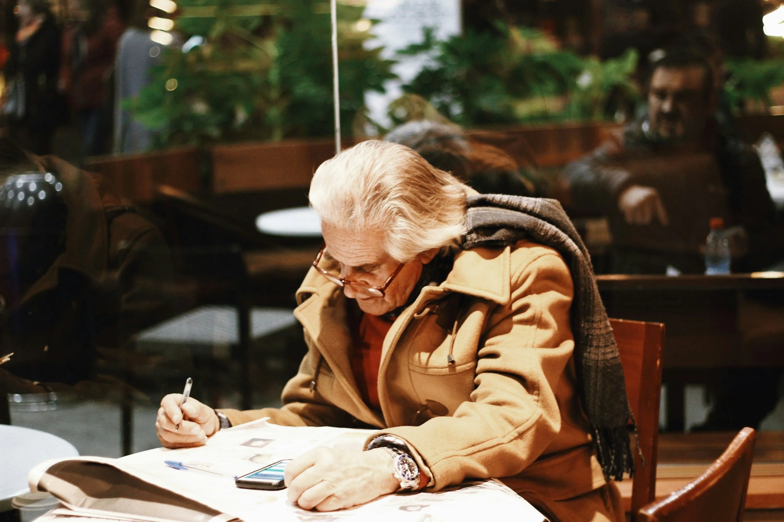 Older gentleman:
Senior signing documents during a mobile notary visit.