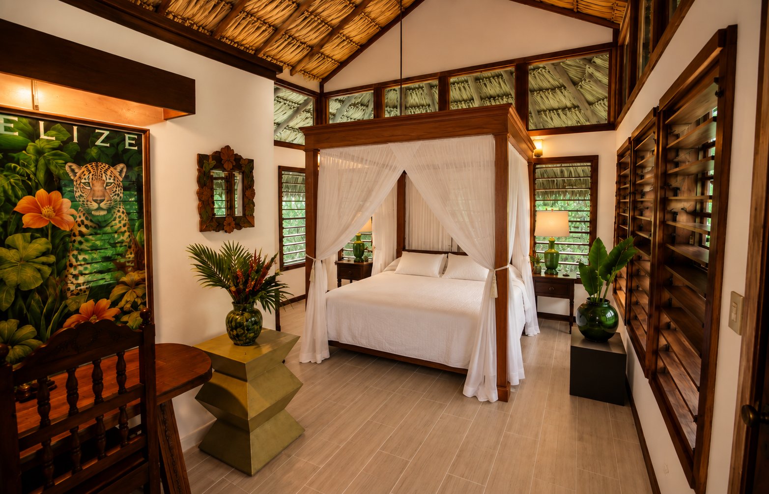 A tropical-style bedroom with a four-poster bed and white curtains, wooden furniture, and lush greenery visible through windows. The room features artwork of a jaguar and vibrant tropical plants.
