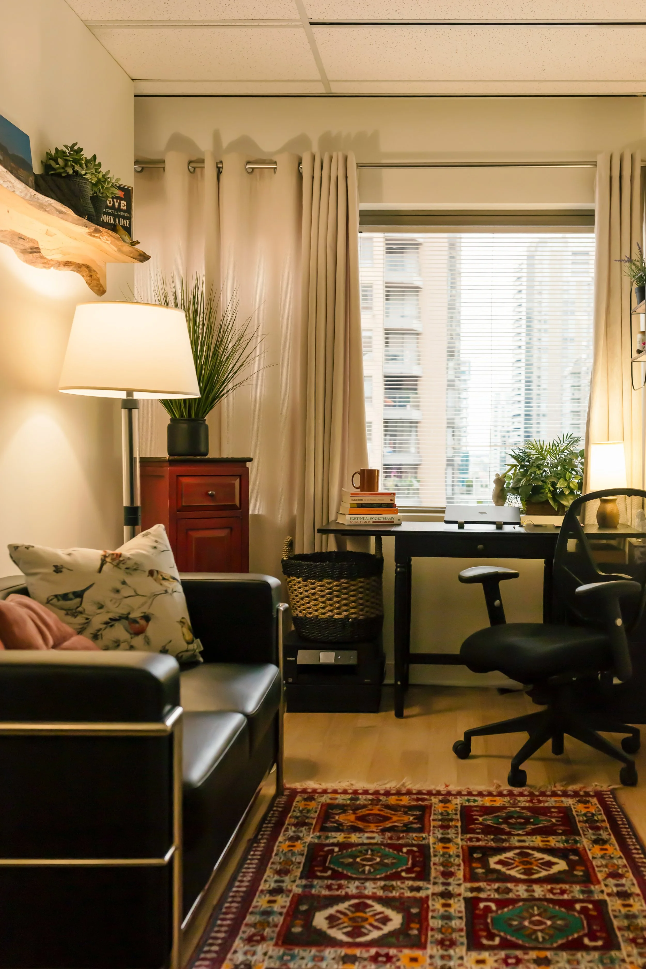 Warm counselling office with seating, natural light, and a large window