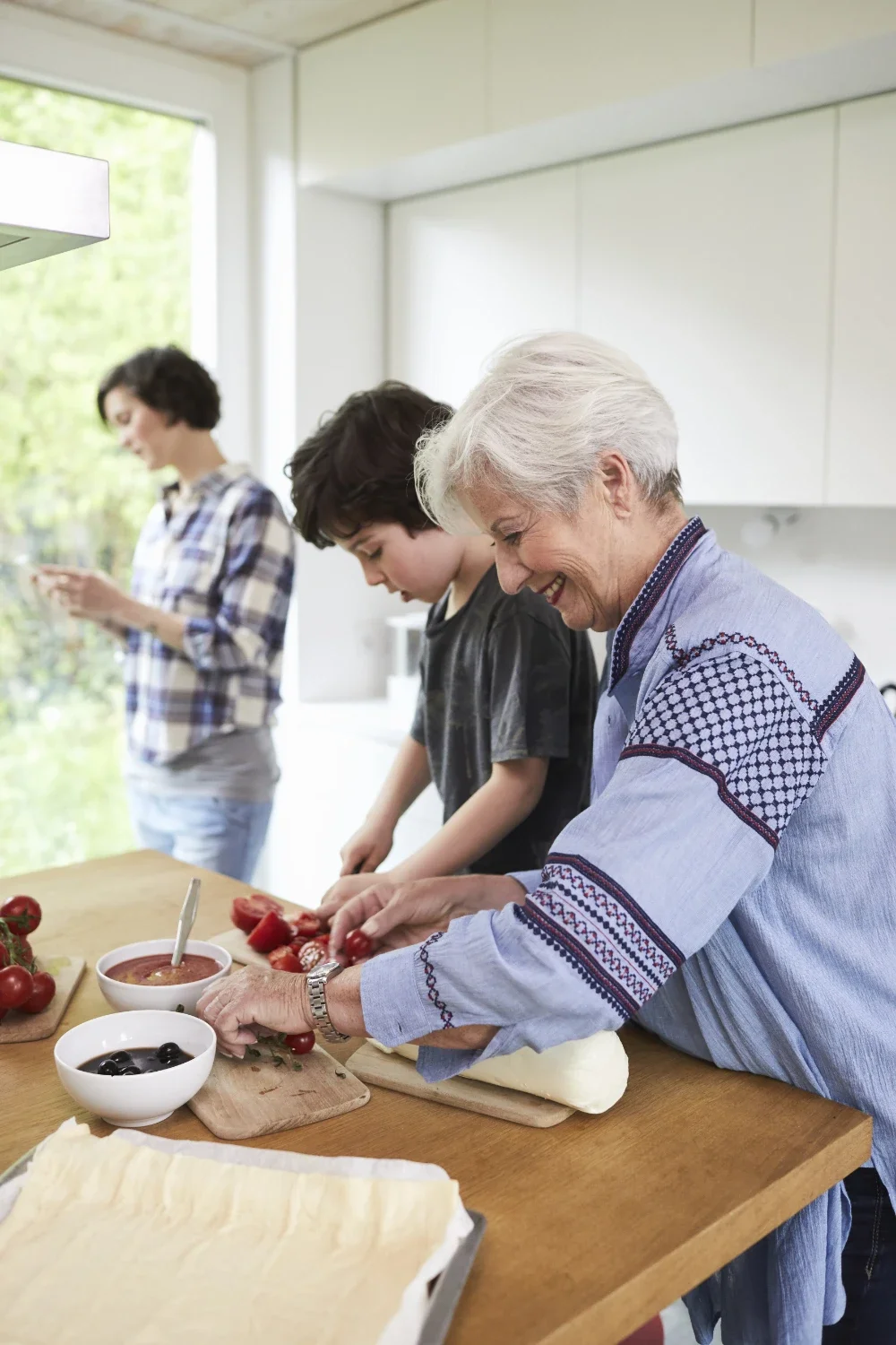 Three generations of women preparing food together