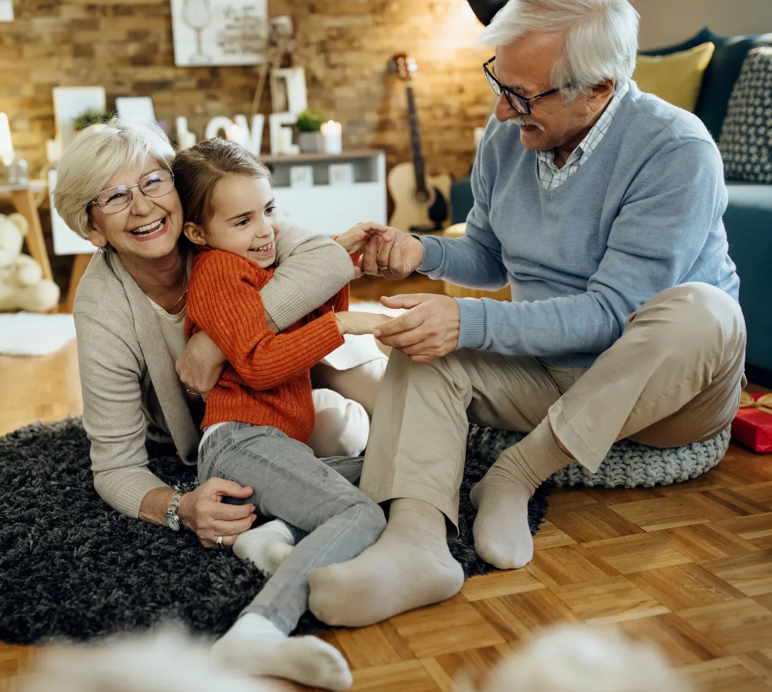 A Couple playing with their grandchild on the floor