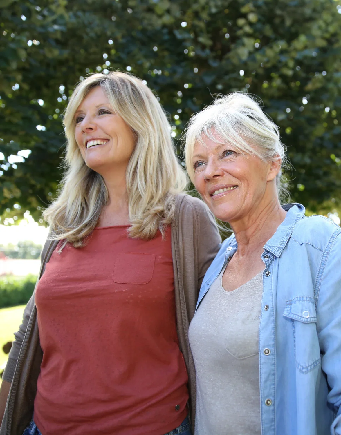 Two smiling women standing outdoors