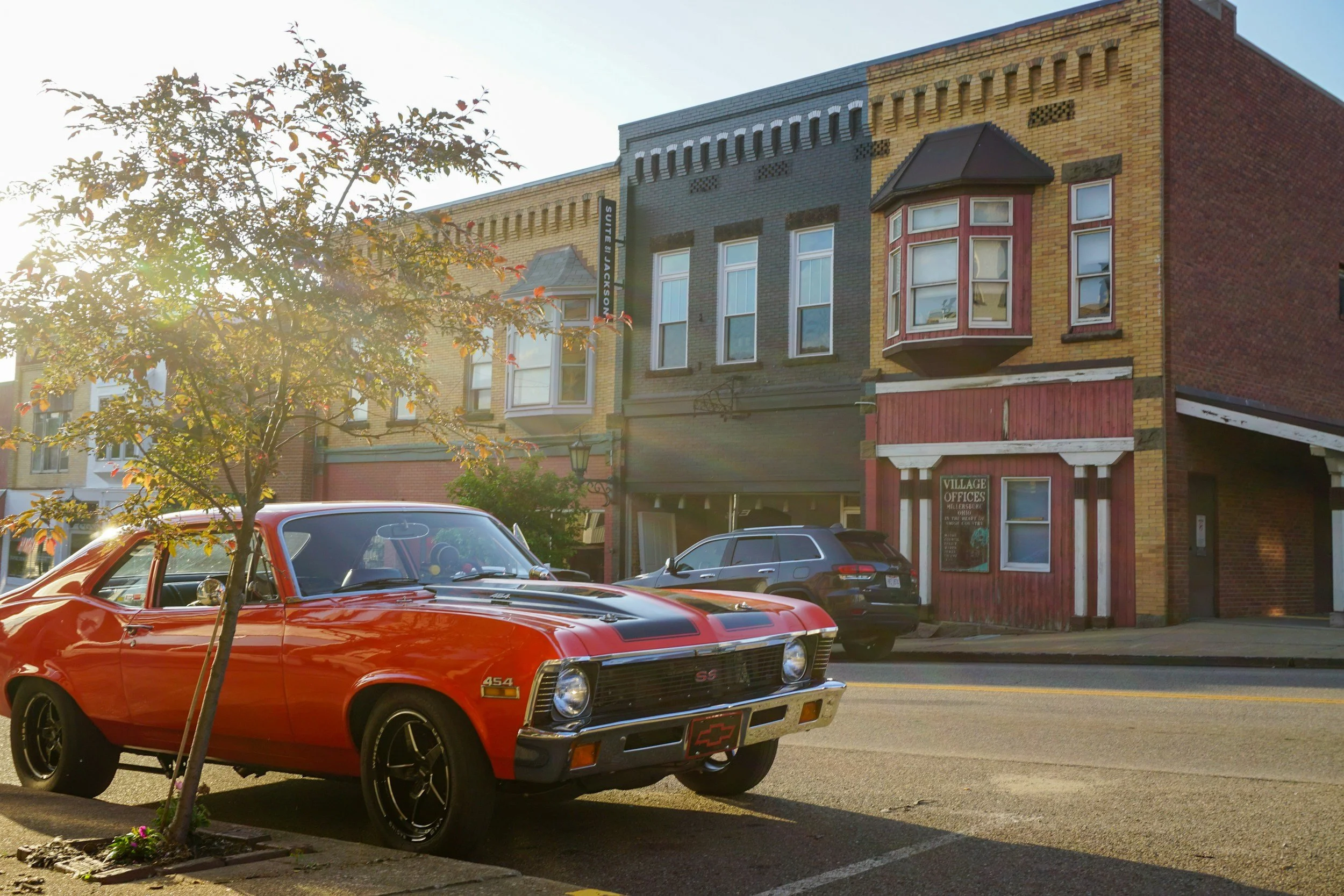Classic red car parked on a brick main street in a small Ohio town