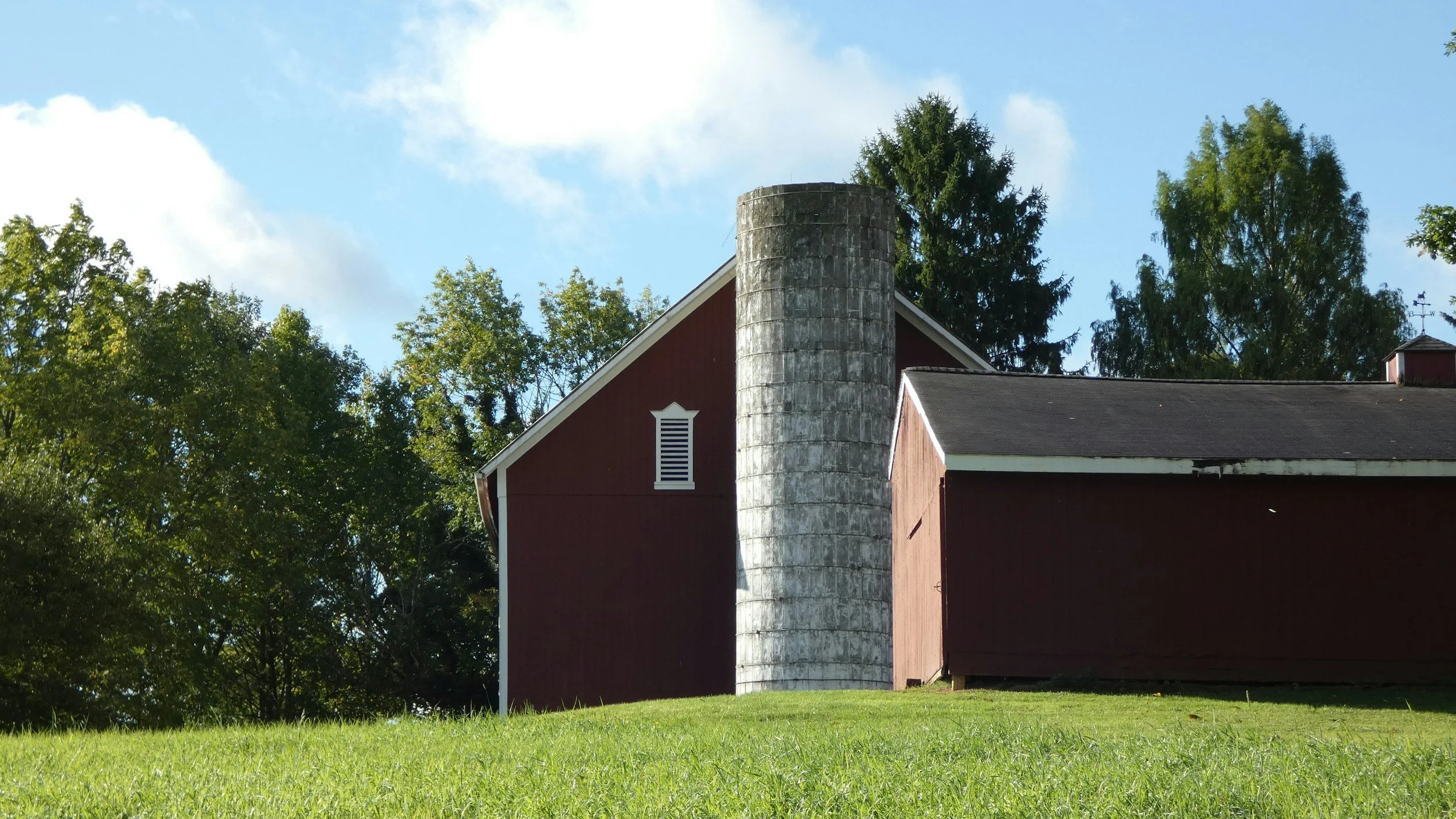Red barn and silo under a blue sky in rural Ohio