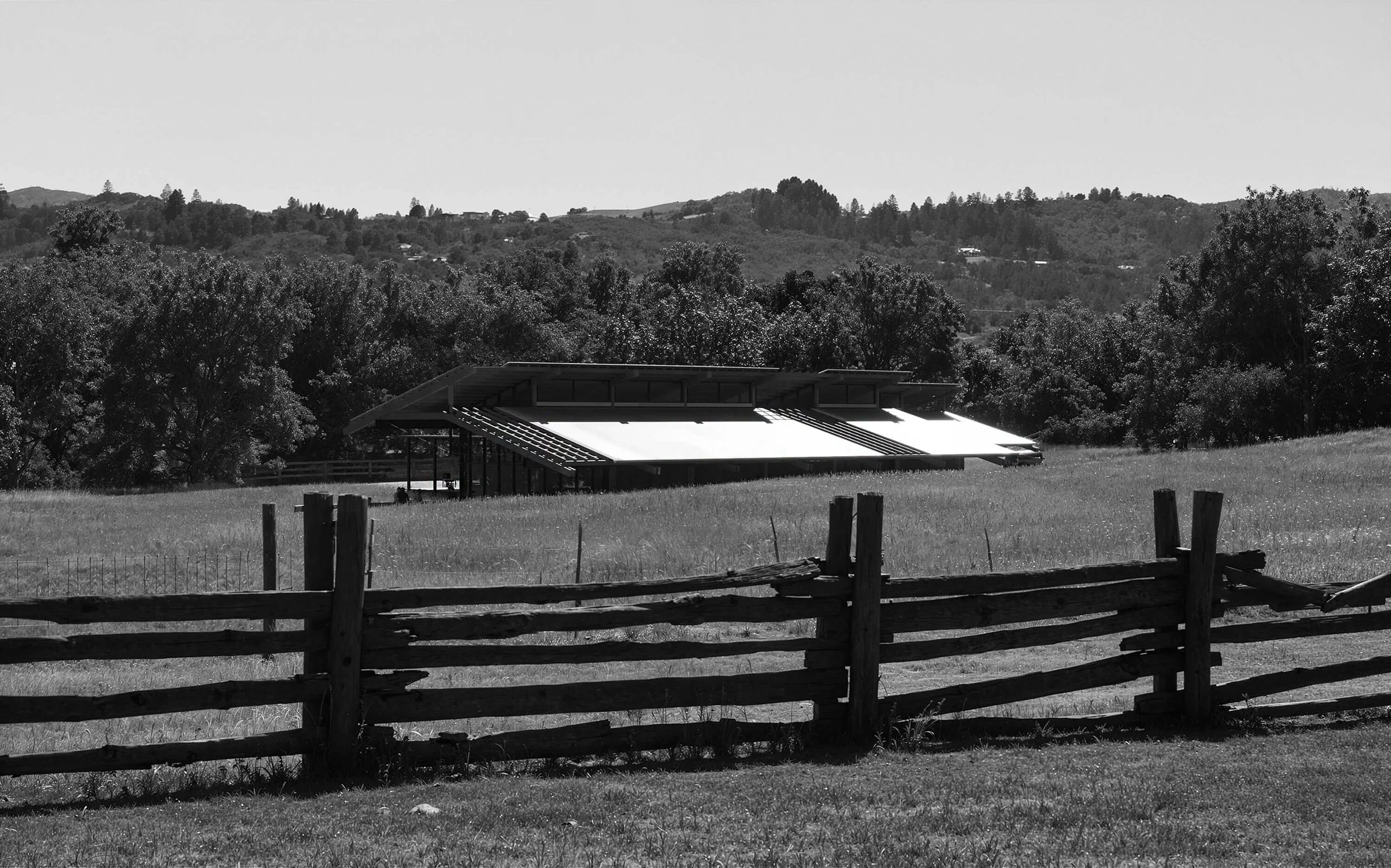 SoCal Rancho sitting low in the meadow behind a rustic wood fence