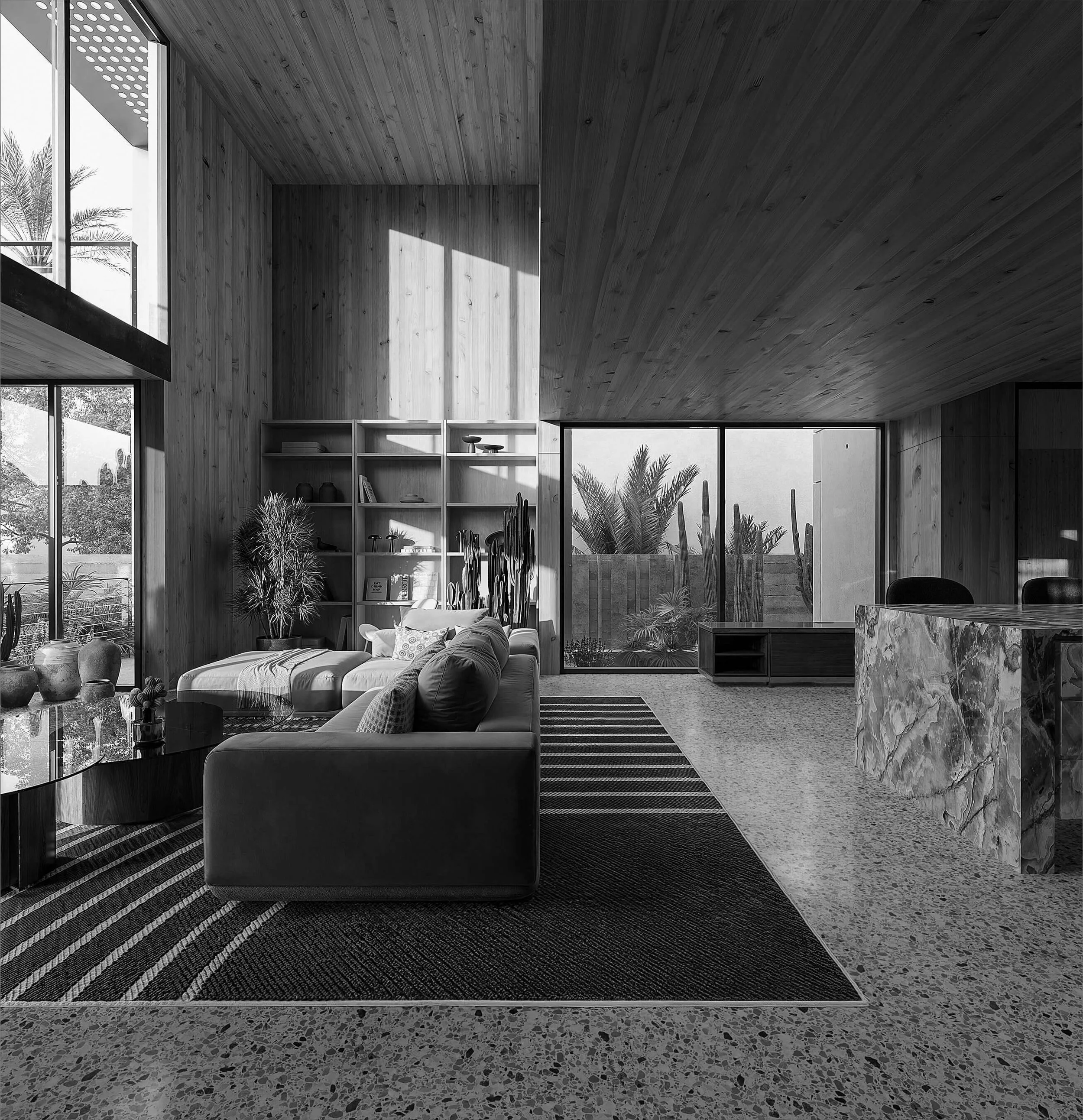 Double-height living space at Dappled House with timber surfaces and daylight from the adjoining courtyard