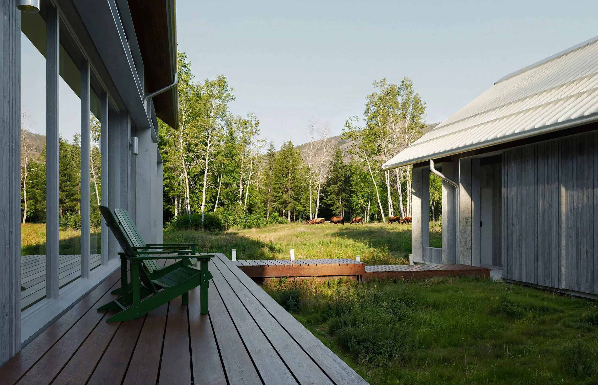 Sheltered courtyard and connecting decks between the barn-like volumes of Big Wood River Ranch