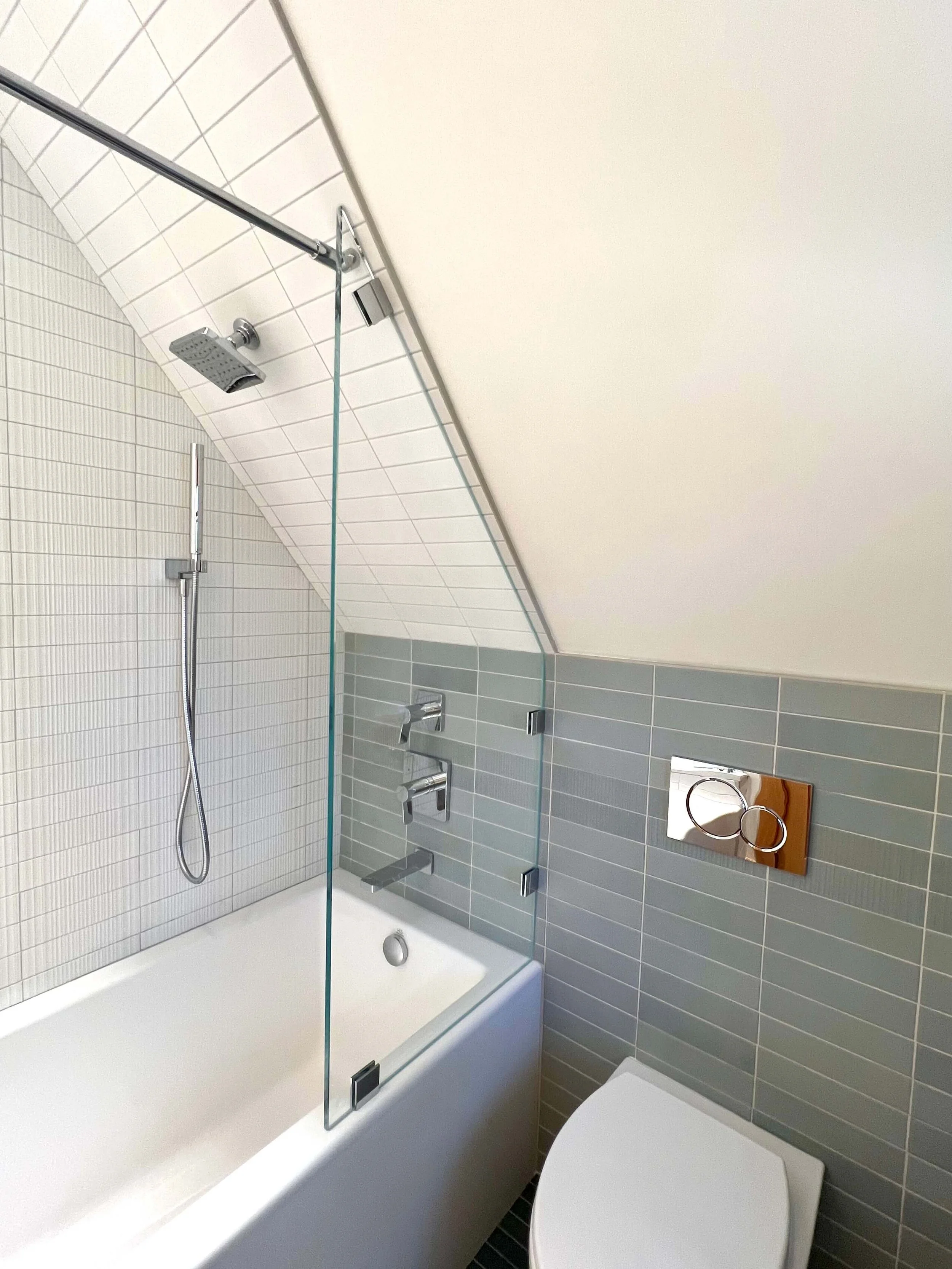 Renovated bathroom fitted beneath the sloping roof of the Saltbox house