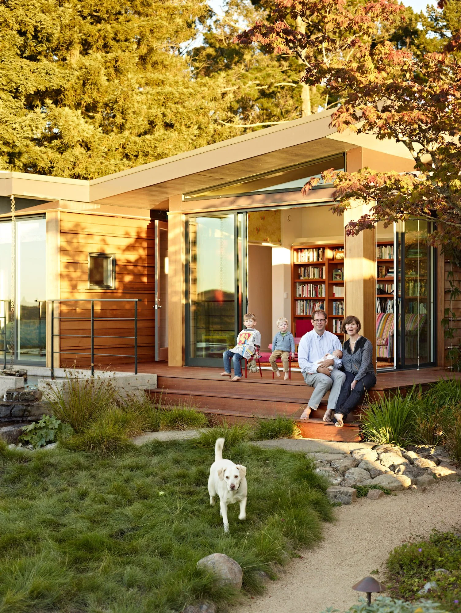 Family gathered on the deck of the Butterfly House pavilion beside the garden