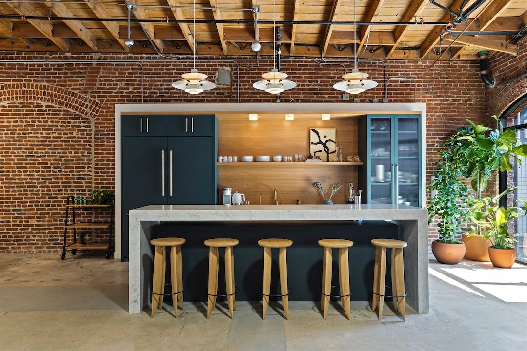 Staff kitchen inserted against the original brick wall and timber ceiling at Pivot Interiors