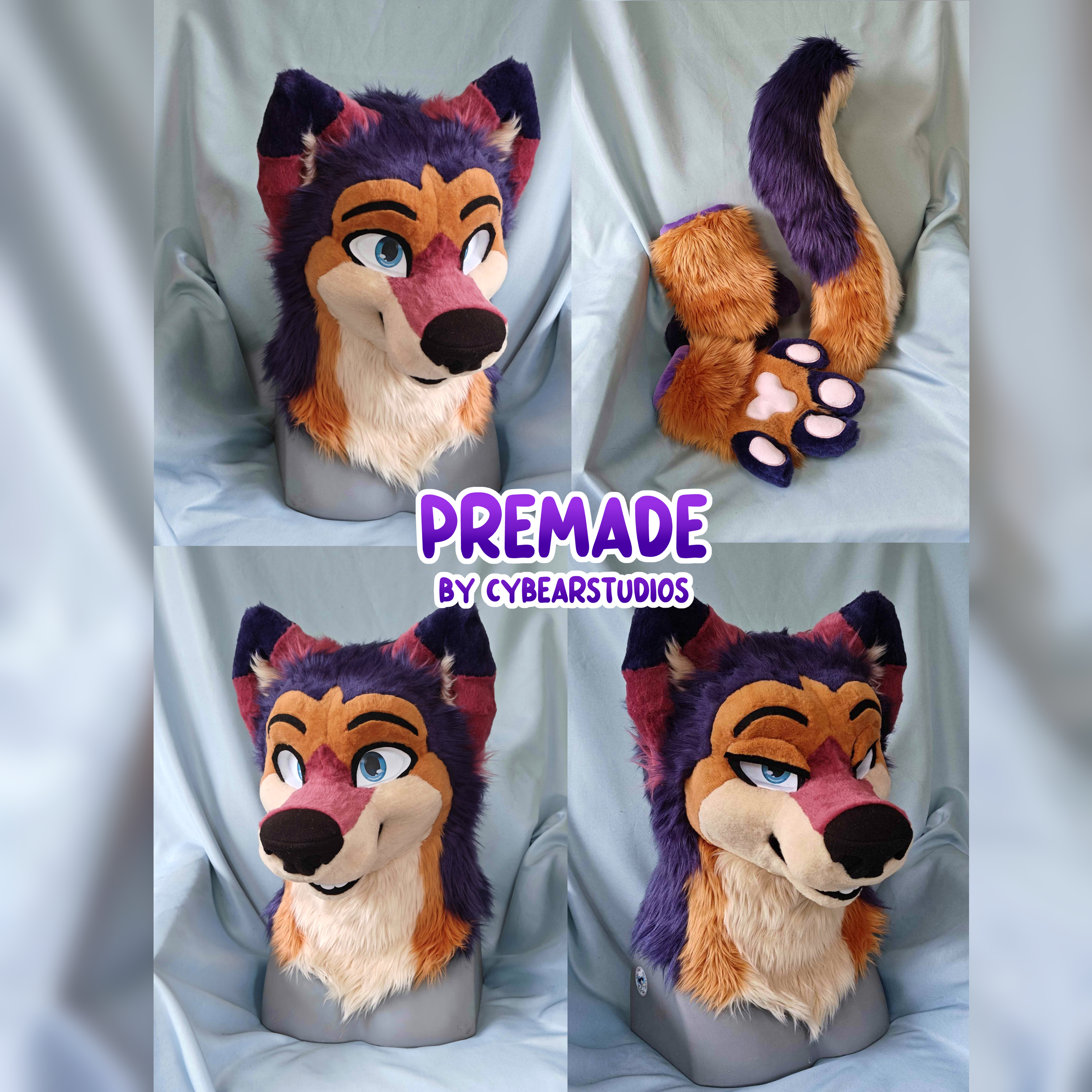 A colorful anthropomorphic fox mascot costume with a purple, orange, and beige fur design, large blue eyes, and a playful expression, displayed on a gray mannequin against a light fabric background.