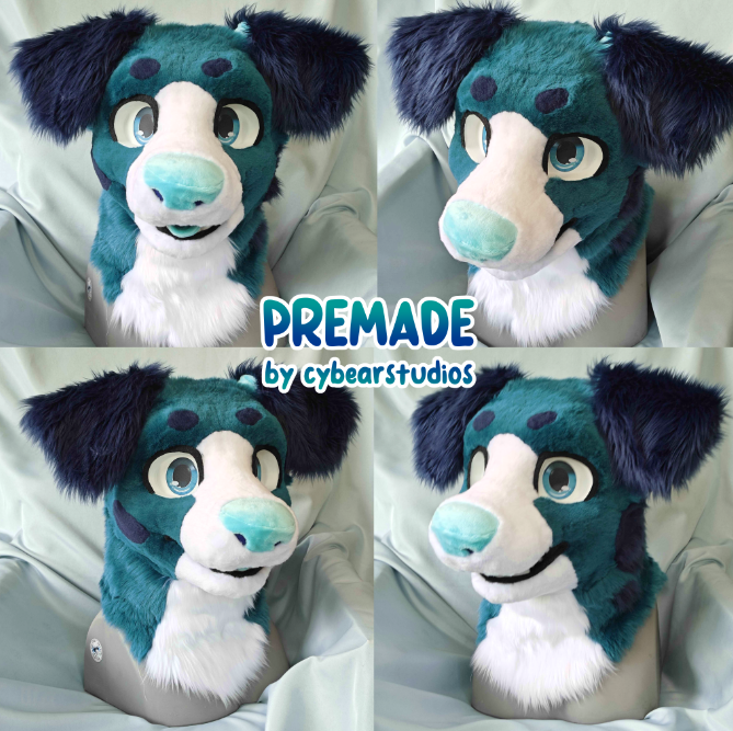 Four photos of a blue and white furry mascot with large ears, big eyes, and a friendly expression, set against a light-colored background. The mascot's face features a light blue nose and dark blue spots, with the text 'PREMADE by cyberstudios' in the center.