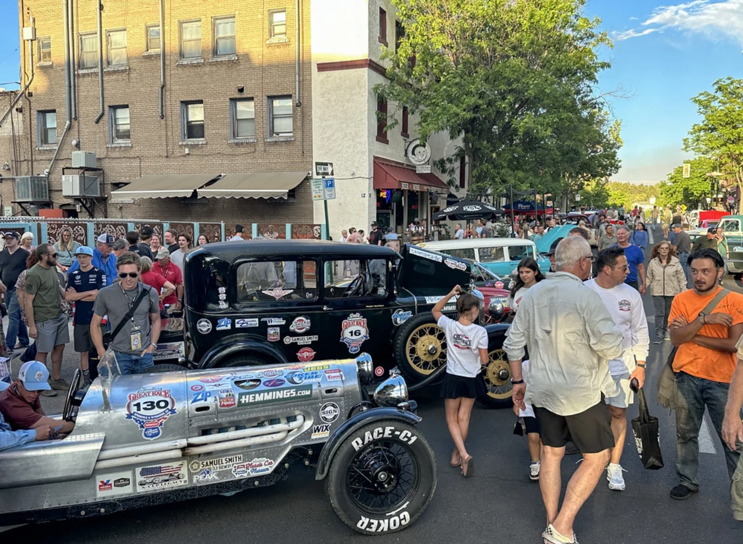 Great Race crowd in Flagstaff with sponsor decals visible on participating cars