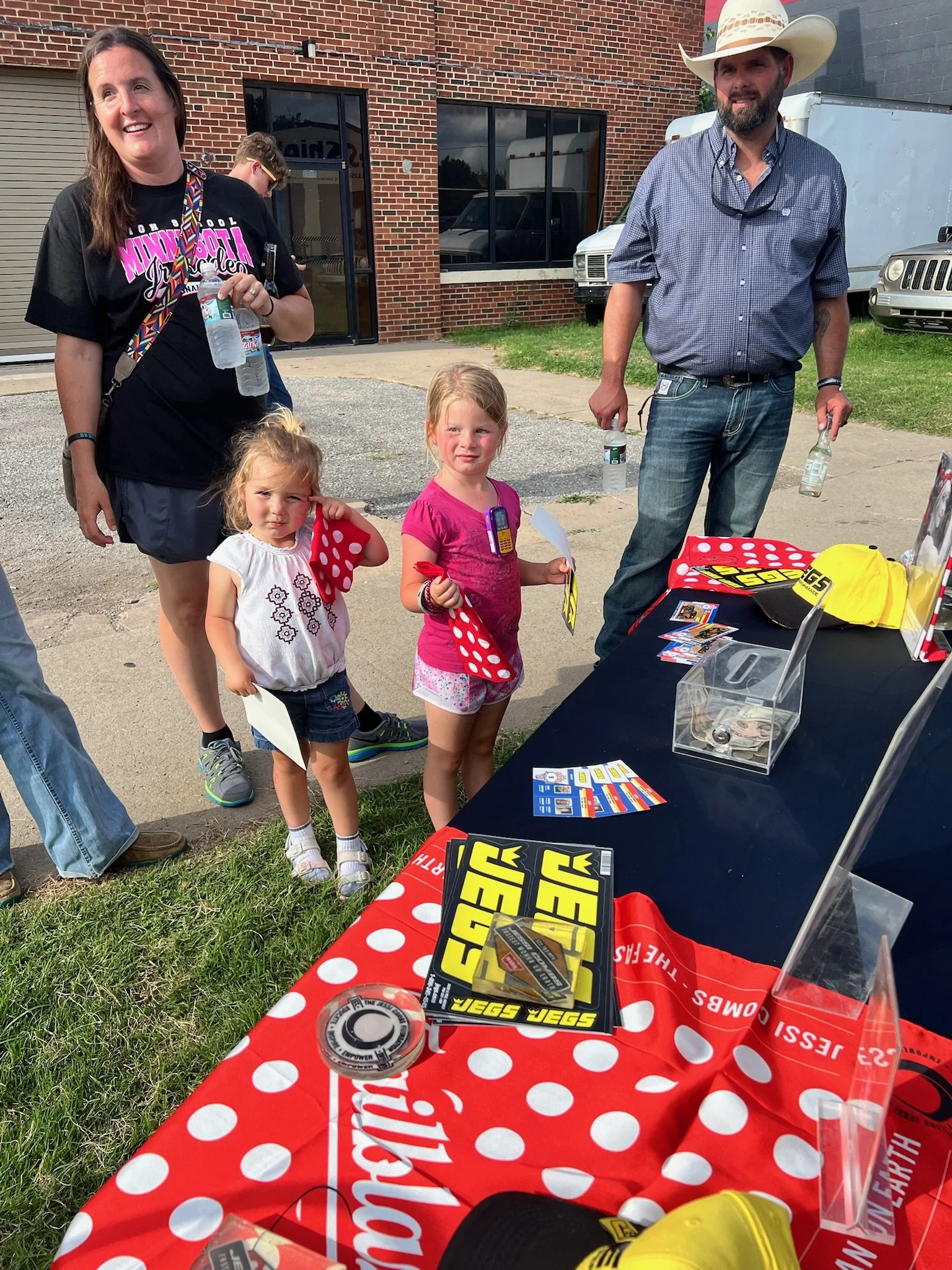 Family engaging with the JEGS display at Great Race