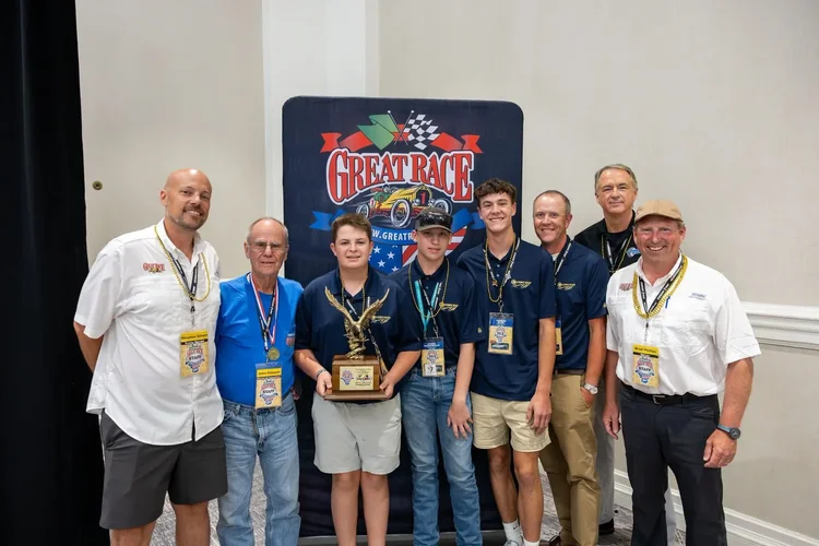 X-Cup students and Great Race team members celebrating with an award
