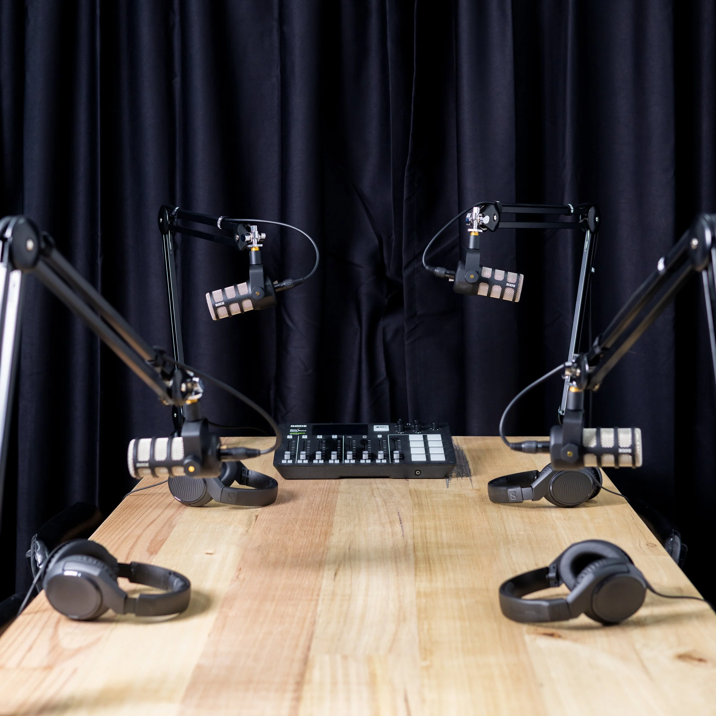 Professional podcast microphones and audio mixer inside the G Studios soundproof Podcast Studio on the Central Coast