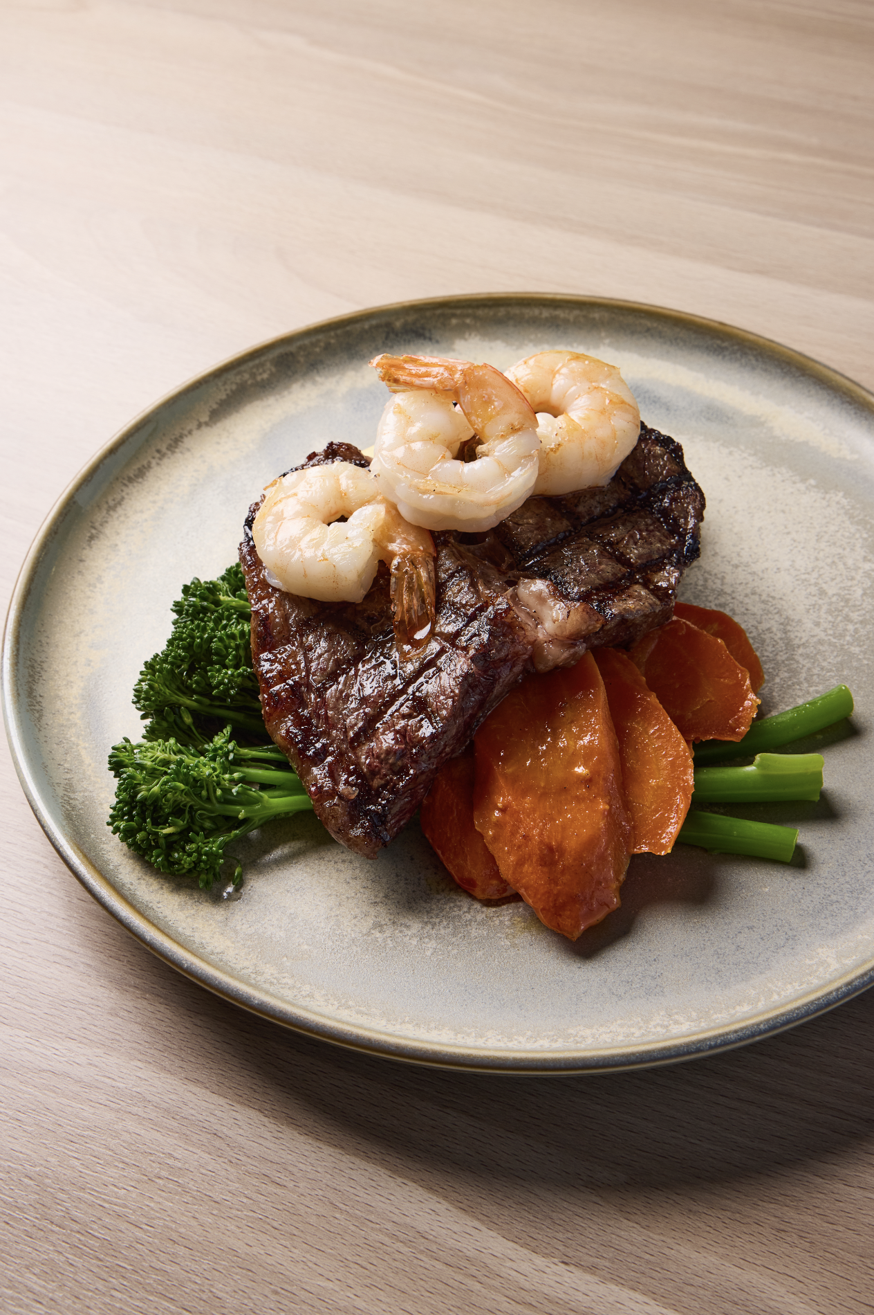 Commercial food photography of steak, prawns and vegetables captured by G Studios for a hospitality client