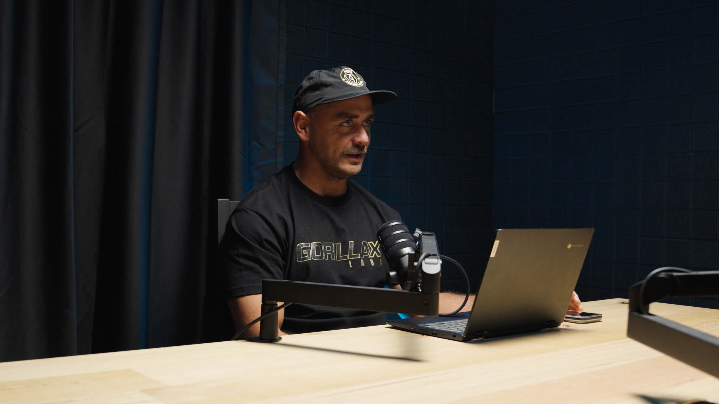 Podcast guest recording with microphone and laptop inside the G Studios Podcast Studio in Tuggerah