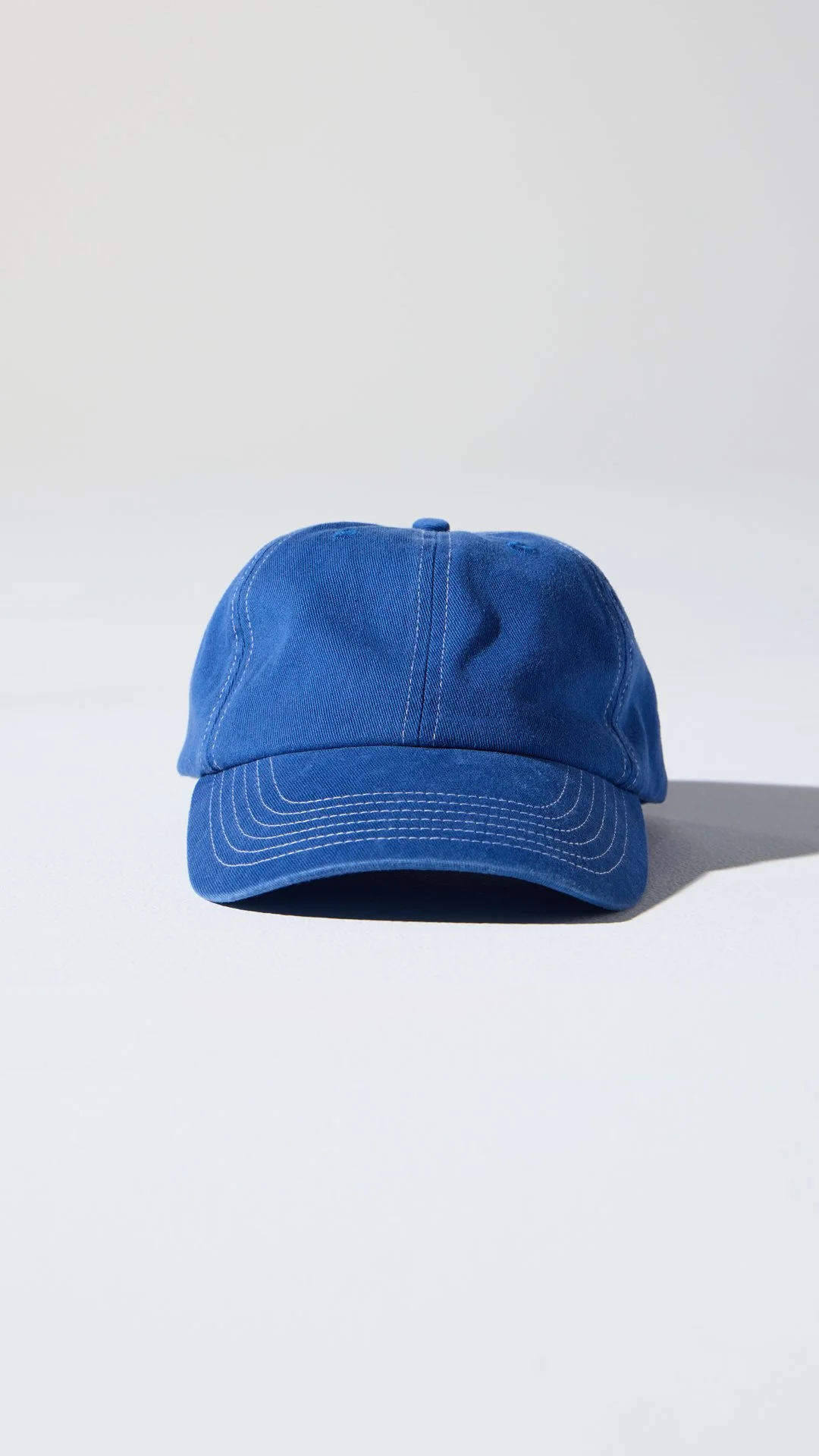 Blue baseball cap photographed by G Studios for clean eCommerce product content