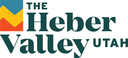 Logo of The Heber Valley in Utah with stylized mountain and valley graphic.