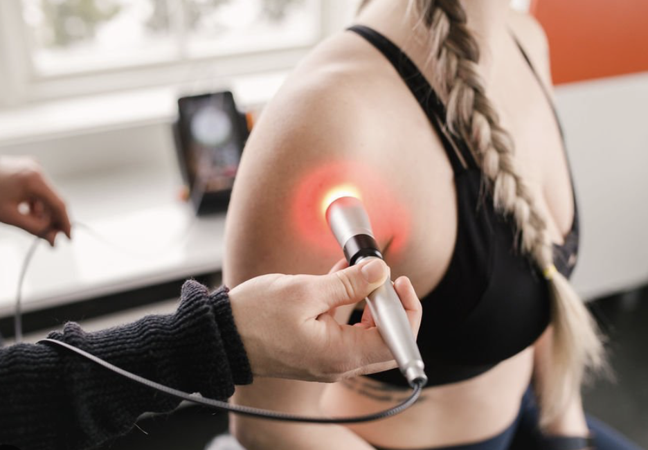 Class IV laser therapy being applied to the shoulder.