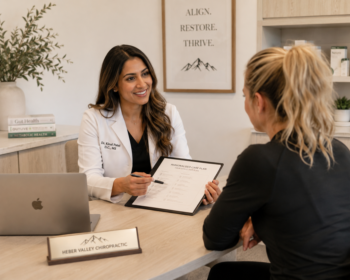 Dr. Kinal Patel discussing a personalized care plan with a patient at Heber Valley Chiropractic.