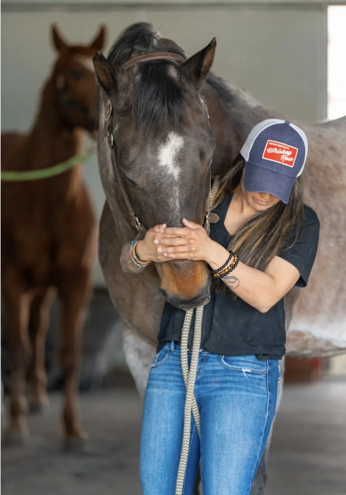Dr. Kinal Patel with a horse as part of her animal chiropractic practice.