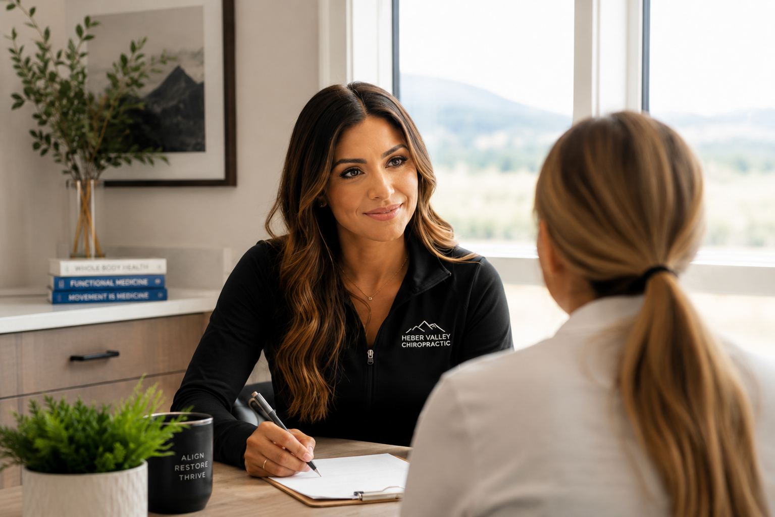 Dr. Kinal Patel consulting with a patient about individualized treatment and wellness goals.