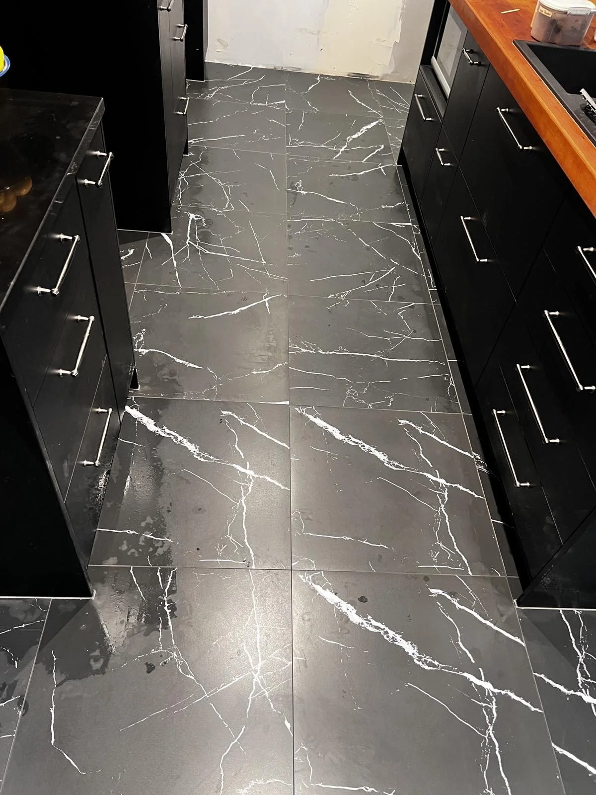 Black marble kitchen flooring with white veining.