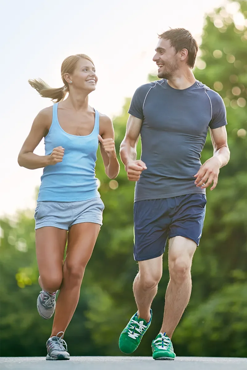 Two runners jogging together outdoors
