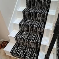 Black decorative metal staircase railing with patterned design