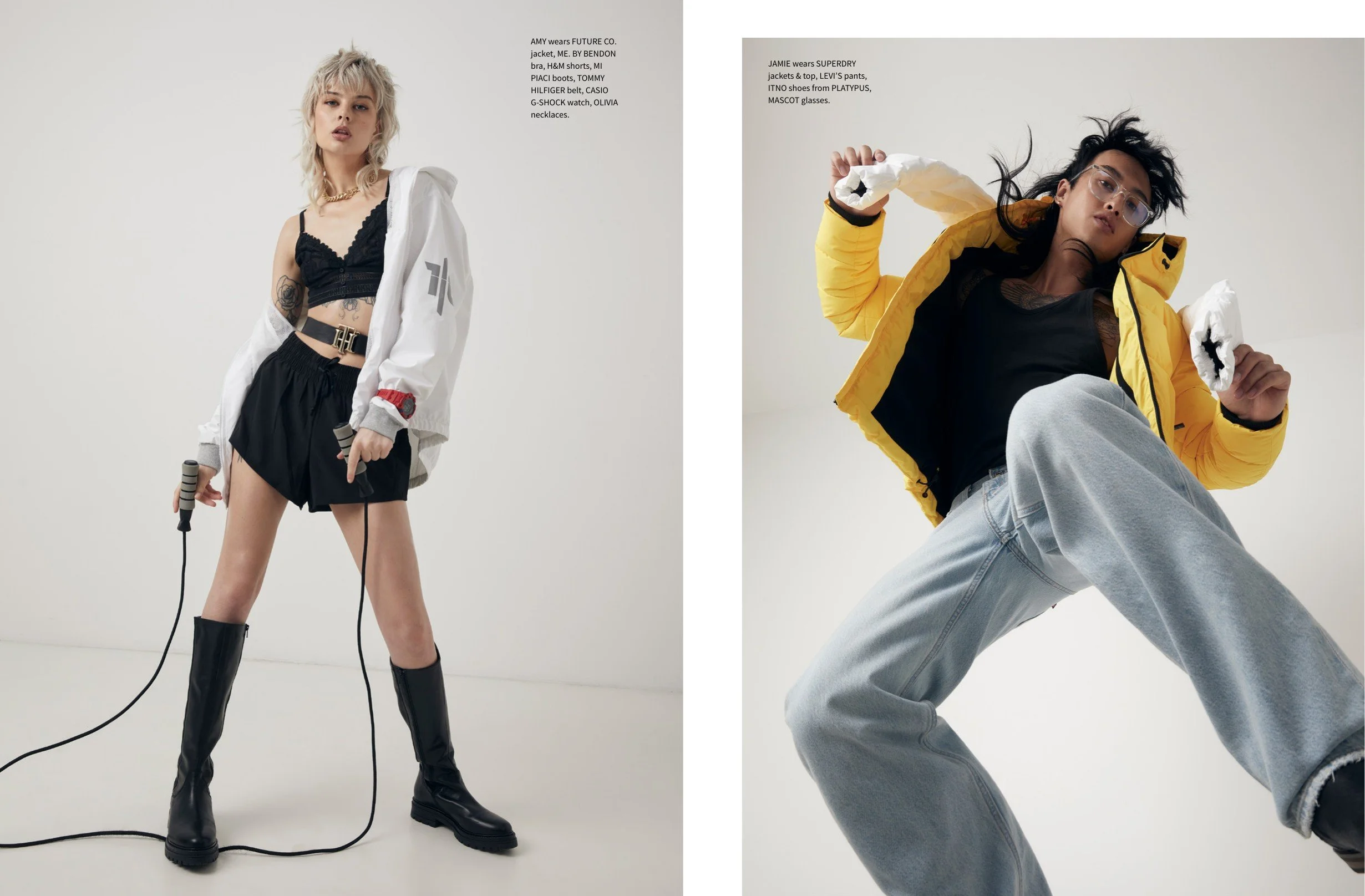 Two young women wearing fashionable streetwear outfits against a plain white background. The woman on the left has blond hair, tattoos, black crop top, black shorts, and boots, holding jump ropes. The woman on the right has black hair, glasses, yellow jacket, gray sweatpants, and is holding a crumpled paper or tissue.