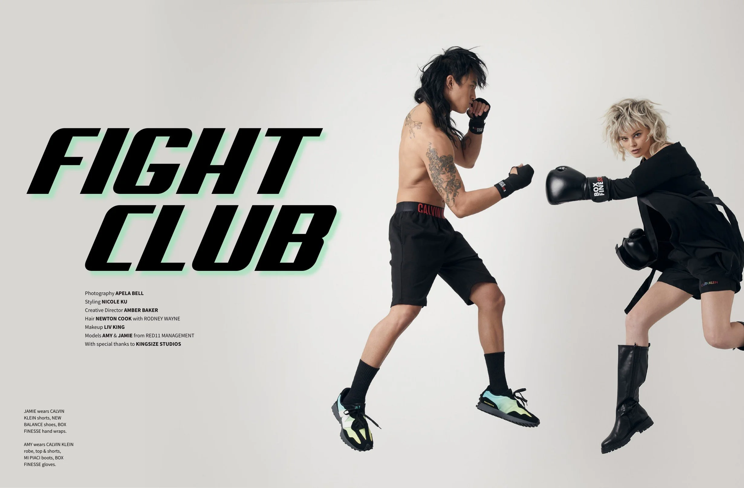 Image of two people engaged in a boxing pose, one with a tattooed torso wearing black shorts and the other wearing black boxing gloves and a black jacket, against a plain white background with the words 'FIGHT CLUB' in bold black letters.