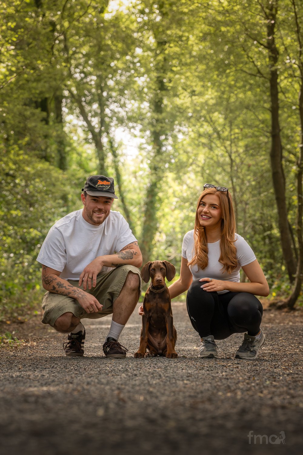Brown Doberman puppy with family