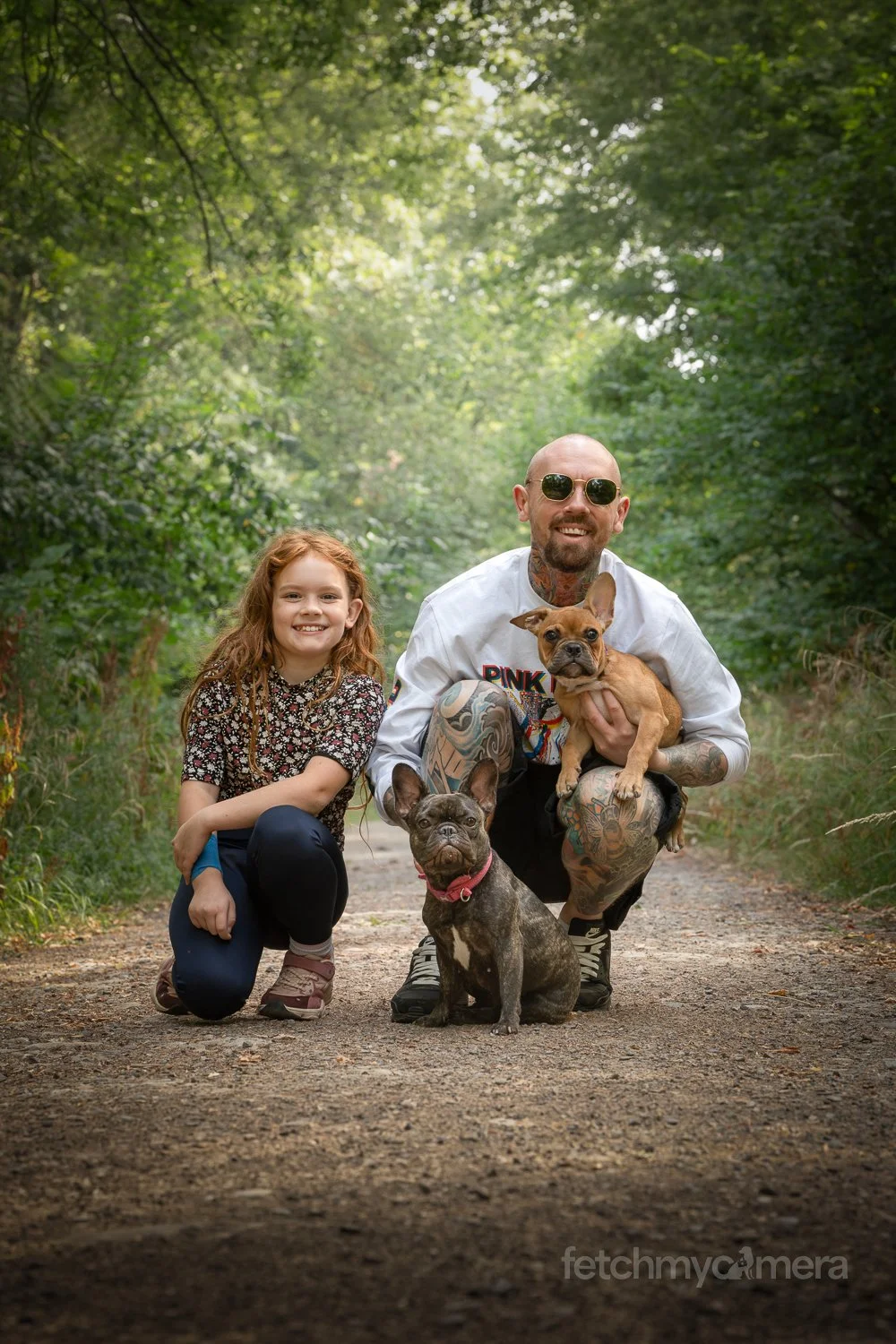 Family with two French Bulldogs