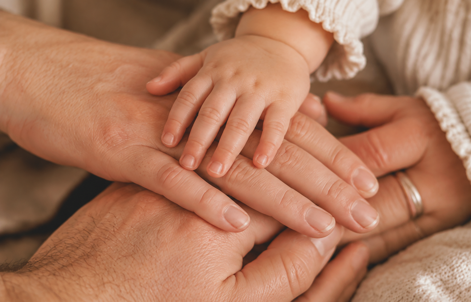 Hands from multiple family members on top of each other