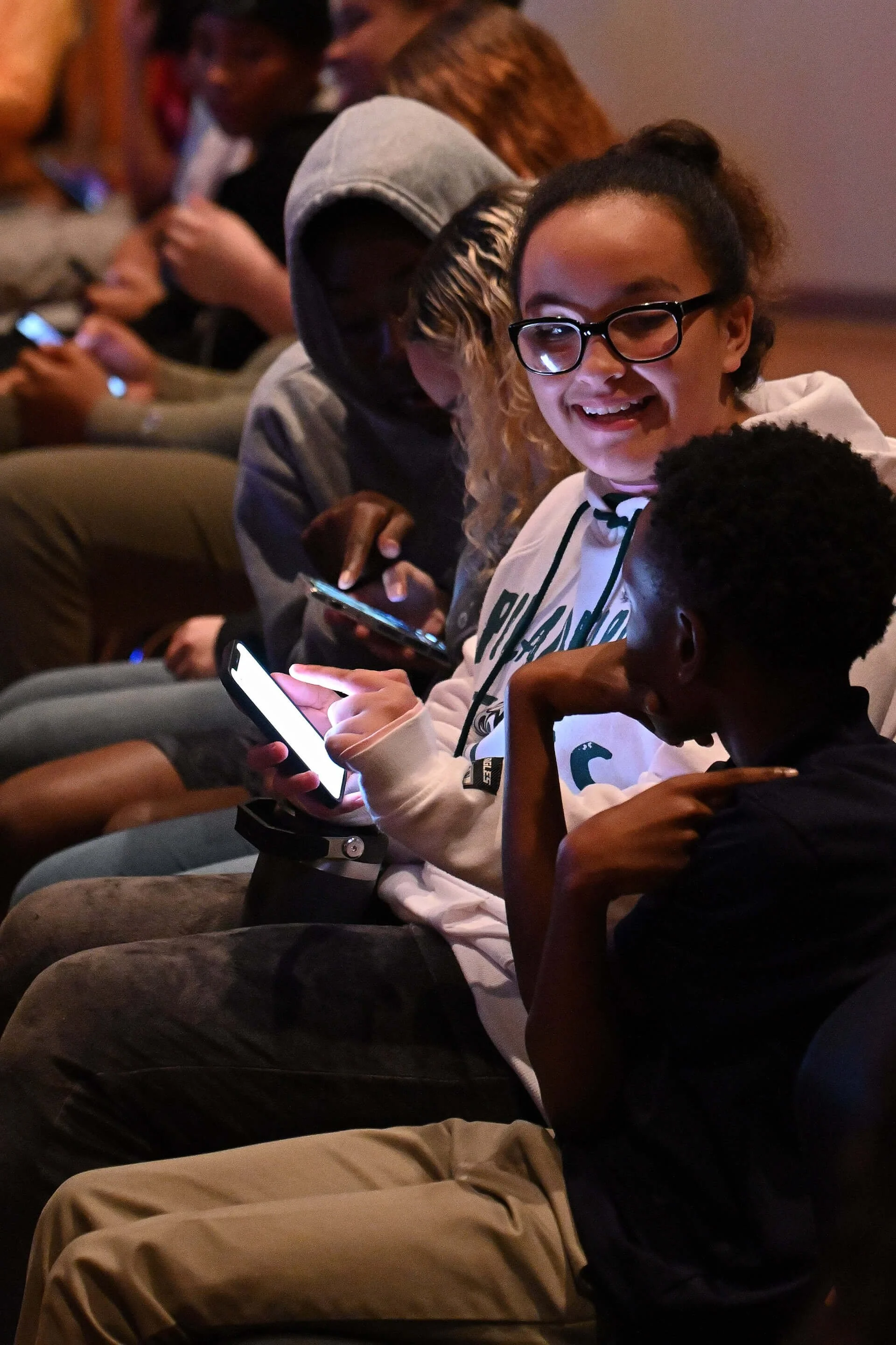 High school students talking on their phones.