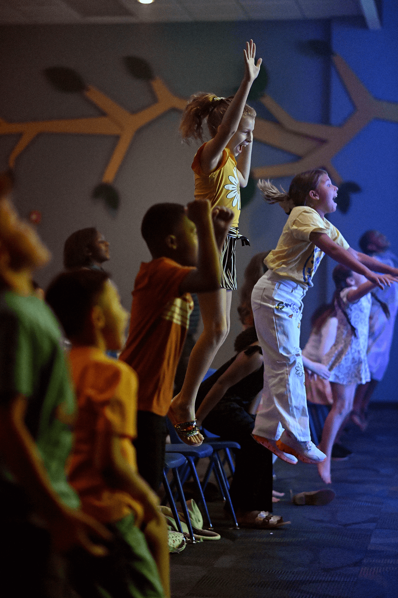 Group of school age kids excitedly engaging in a kids service at Family Worship Center.