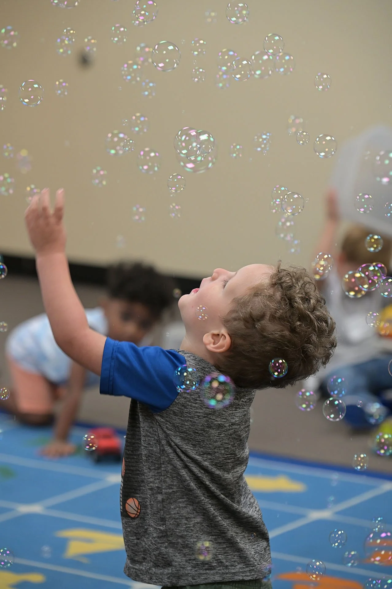 Toddler happily playing with bubbles