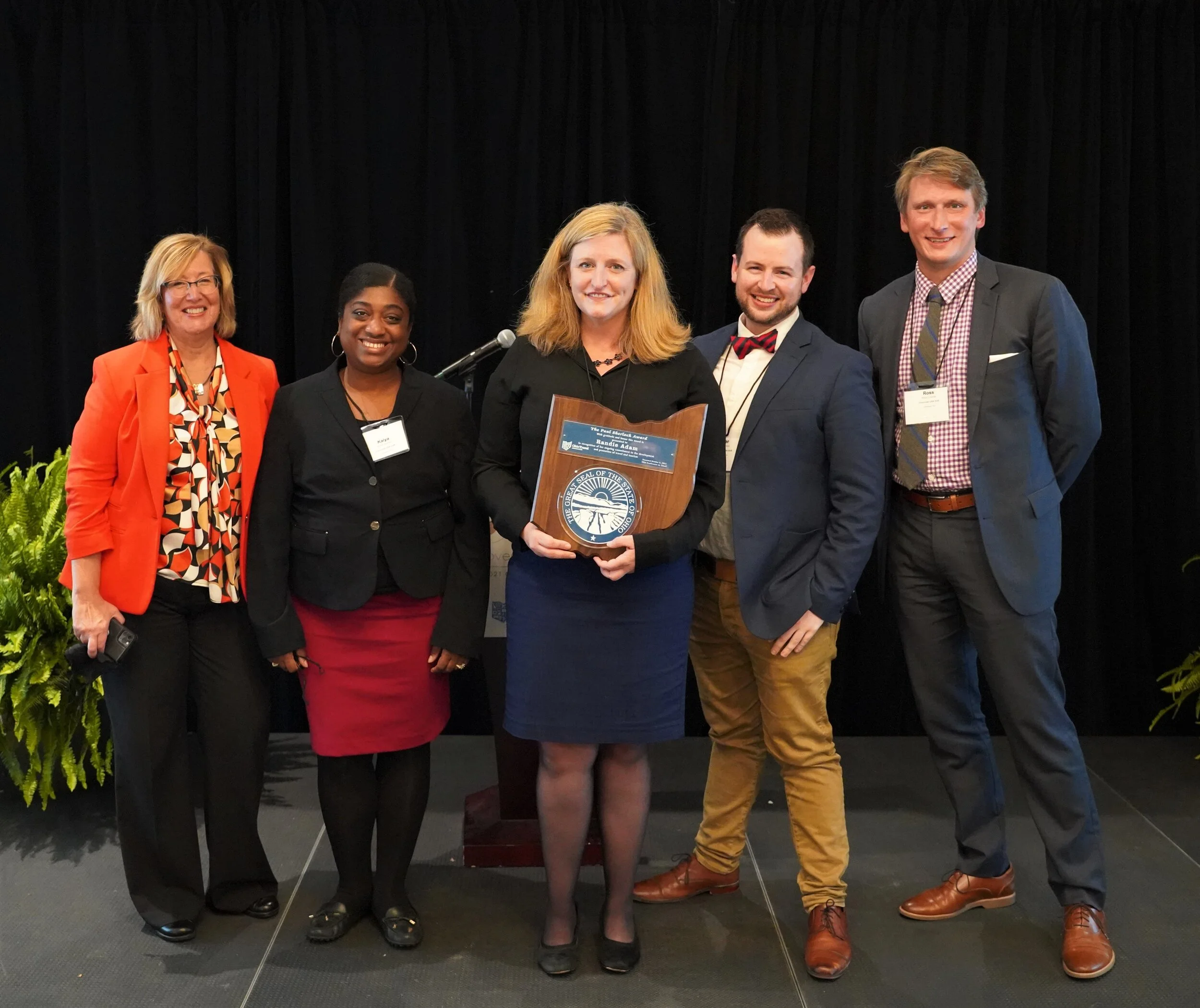 Cincinnati USA Convention &amp; Visitors Bureau colleagues congratulate Randie&nbsp;Adam: Cindi Flick, Kaiya Barrett,&nbsp;Randie&nbsp;Adam (center), Tyler Minton, Ross Czarnik