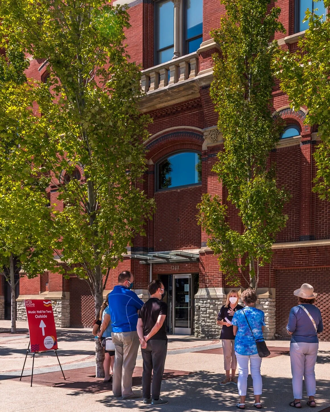 Volunteer Becky Moegenberg answers guests questions during an Outdoor Building Tour. These are held Thursday afternoons and Saturday mornings this fall.