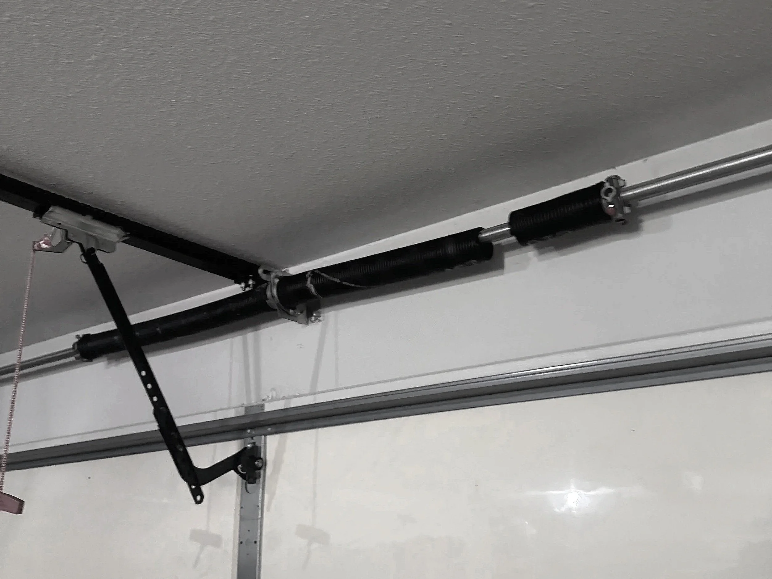 broken garage door spring above the door